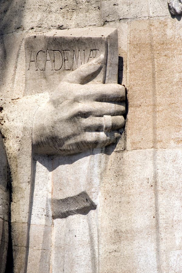 Detail of the statue of Theodore de Beze on the Refomation Wall in the Parc des Bastions in Geneva Switzerland. The statue is holding a book promoting academia. Detail of the statue of Theodore de Beze on the Refomation Wall in the Parc des Bastions in Geneva Switzerland. The statue is holding a book promoting academia.