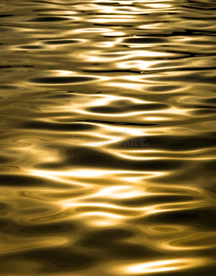 Detail of waves in a swimming pool with a golden tone due to the sunset behind. Detail of waves in a swimming pool with a golden tone due to the sunset behind.