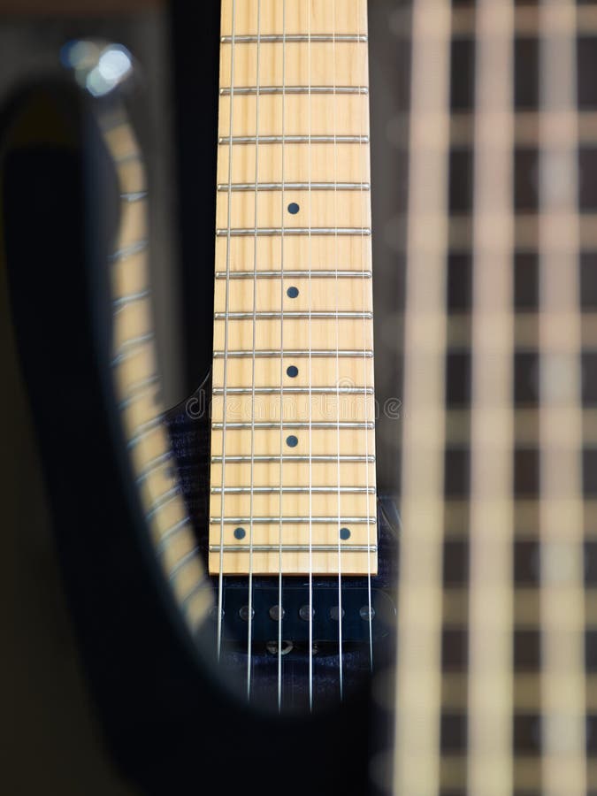 Detail of electric guitar cords and frets