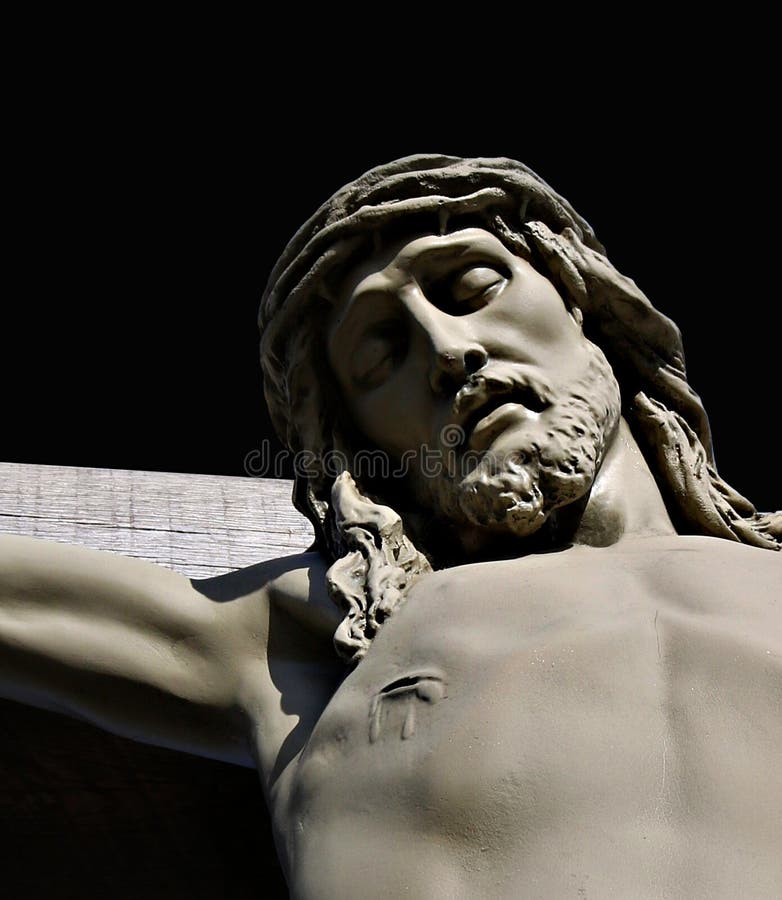 Detail of face and spear wound of statue of Jesus on cross