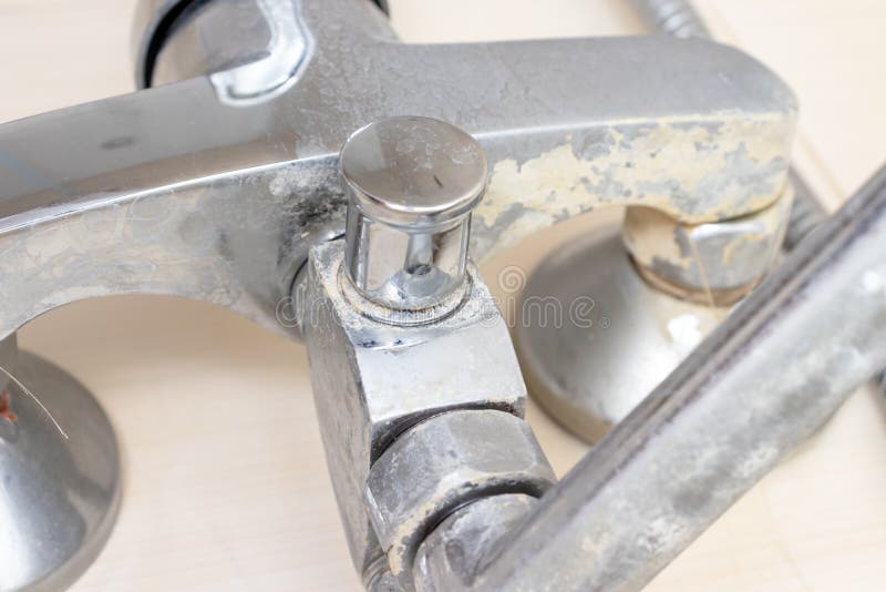 Detail of faucet with limescale or lime scale on it, dirty calcified and rusty shower mixer tap, close up stock photography