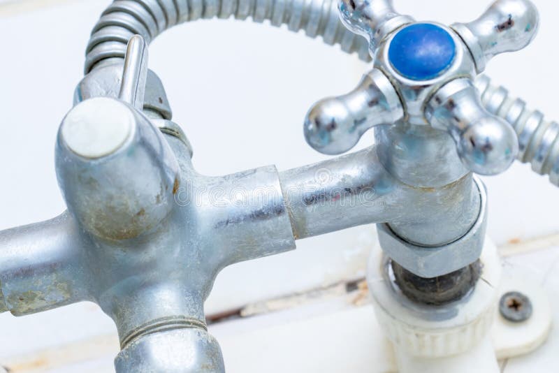 Detail of faucet with limescale or lime scale on it, dirty calcified and rusty shower mixer tap, close up royalty free stock image