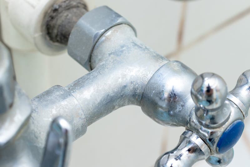 Detail of faucet with limescale or lime scale on it, dirty calcified and rusty shower mixer tap, close up stock photo