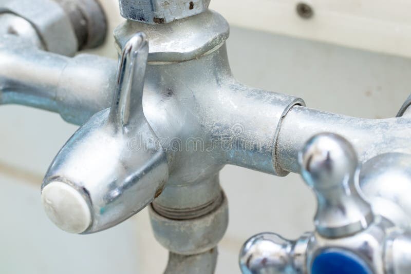 Detail of faucet with limescale or lime scale on it, dirty calcified and rusty shower mixer tap, close up stock photo