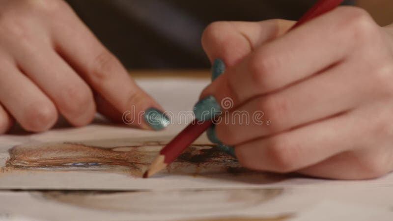 Detail of girl artist hands drawing with a pencil