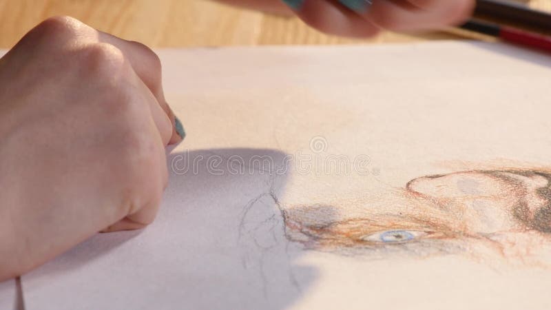 Detail of girl artist hands drawing with a pencil