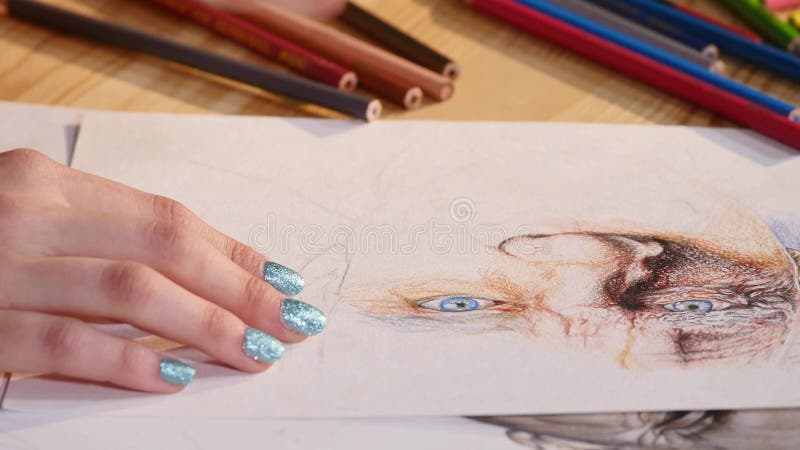 Detail of girl artist hands drawing with a pencil