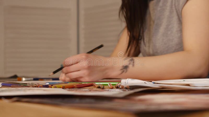 Detail of girl artist hands drawing with a pencil