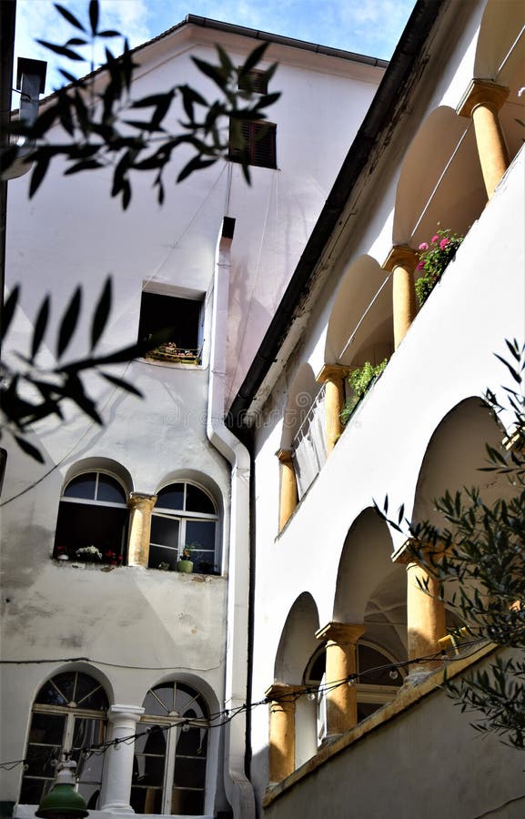 Detail of a house with arcades on the first and second floors, with flower pots, inside a courtyard in Graz. stock image Detail of a house with arcades on the first and second floors, with flower pots, inside a courtyard in Graz. stock image