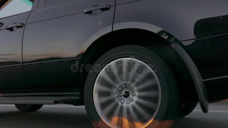 Detail of moving car wheel. The wheel of a moving car, a spinning car wheel