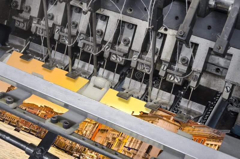 Detail of offset print book stitching machine stock photography