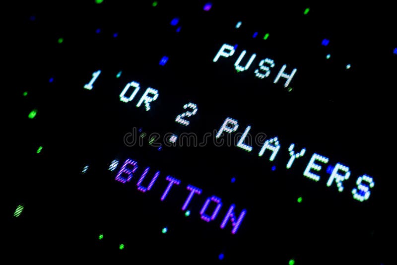 Detail on an old arcade video screen with text Push 1 or 2 players button