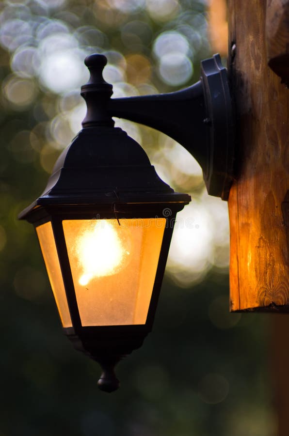 Detail of an old fashioned lantern on a wooden lodge royalty free stock photos