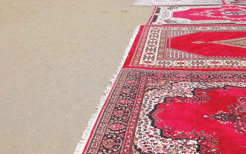 Detail of the Oriental Carpet Resting on the Sand of the Beach Stock