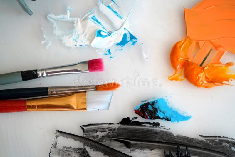 Detail of Paint Brushes and Bright Paint in an Artistâ€™s Studio Stock