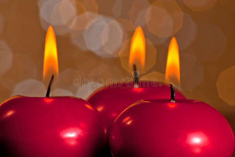 Detail of red christmas candles on golden bokeh background royalty free stock photo Detail of red christmas candles on golden bokeh background royalty free stock photo