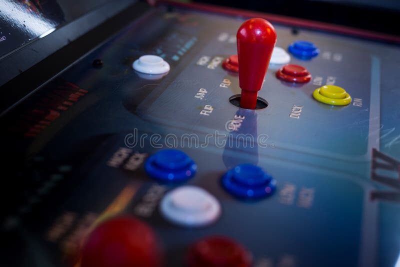 Detail on a red joysticks on and old arcade