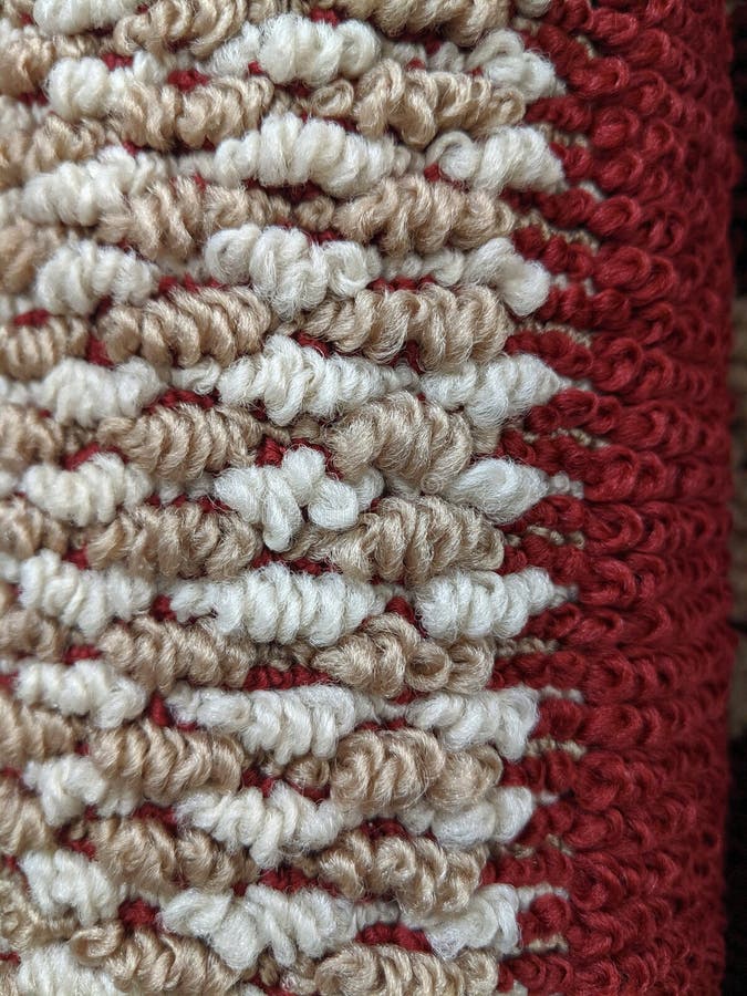 Detail Of A Rug In White, Tan And Dark Red. Close up detail of a rolled up area rug in white, tan and dark red in a checkered type pattern royalty free stock images Detail Of A Rug In White, Tan And Dark Red. Close up detail of a rolled up area rug in white, tan and dark red in a checkered type pattern royalty free stock images