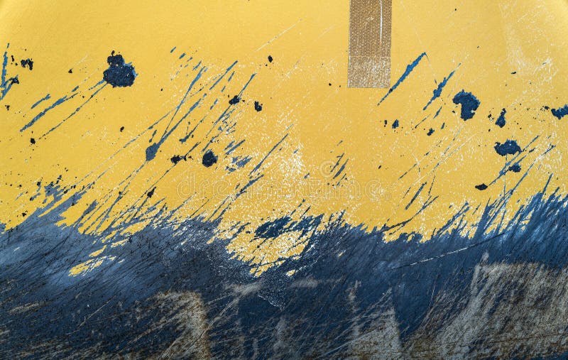 Detail of the scratched surface of a metal plate painted yellow royalty free stock photo