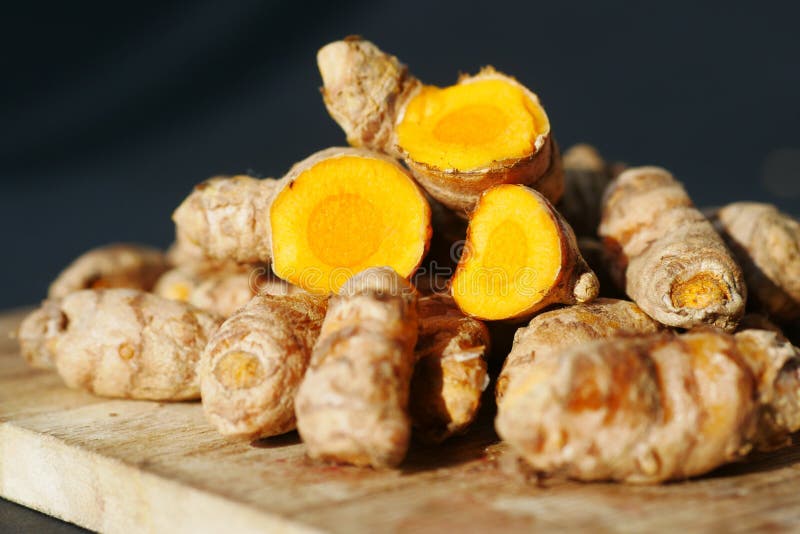 Detail Shot of Turmeric Root in Bowl on Table , Stock Photo Image of