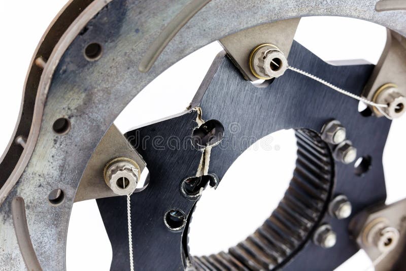 Detail of a sprint car brake rotor that has cracked and warped due to extreme stress. Isolated on white.