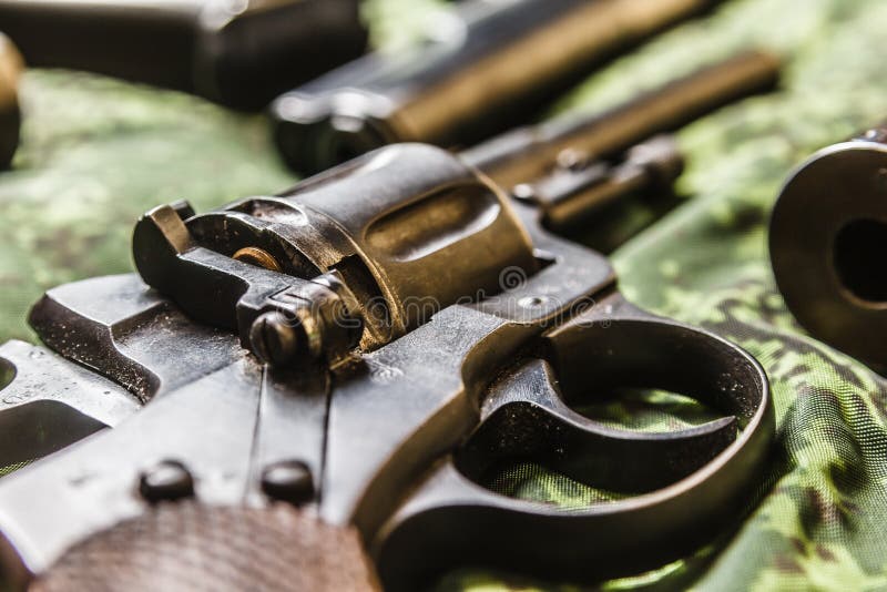 Detail of vintage generic 9mm pistol on pixel camouflage royalty free stock photo
