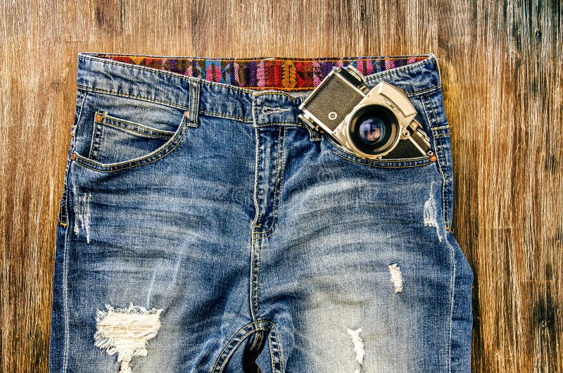 Detail of vintage jeans with classic camera royalty free stock images