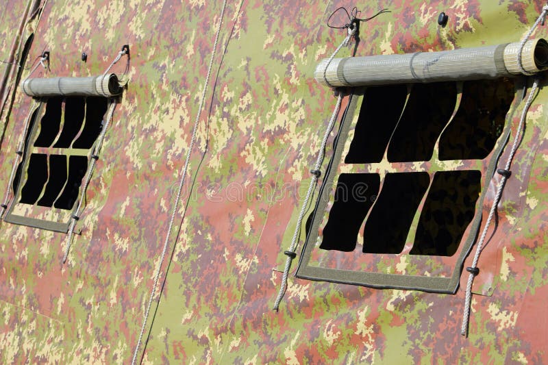 Detail of windows of a military tent with camouflage fabric without people inside stock images