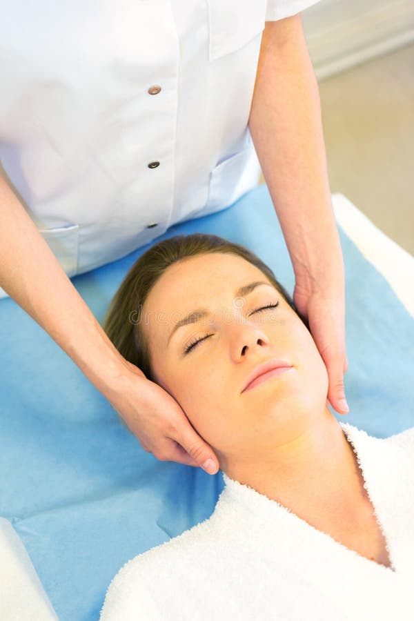 Detail Of A Woman Face Receiving A Relaxing Facial Massage Stock Image