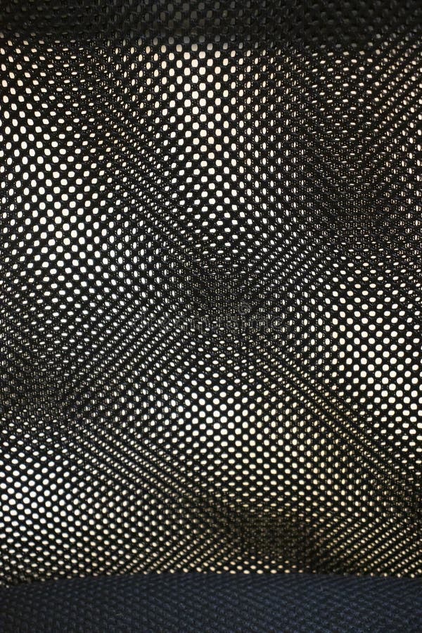 A detailed close-up of a textured fabric with a perforated pattern, creating an intriguing visual effect. Ideal for desi stock photography
