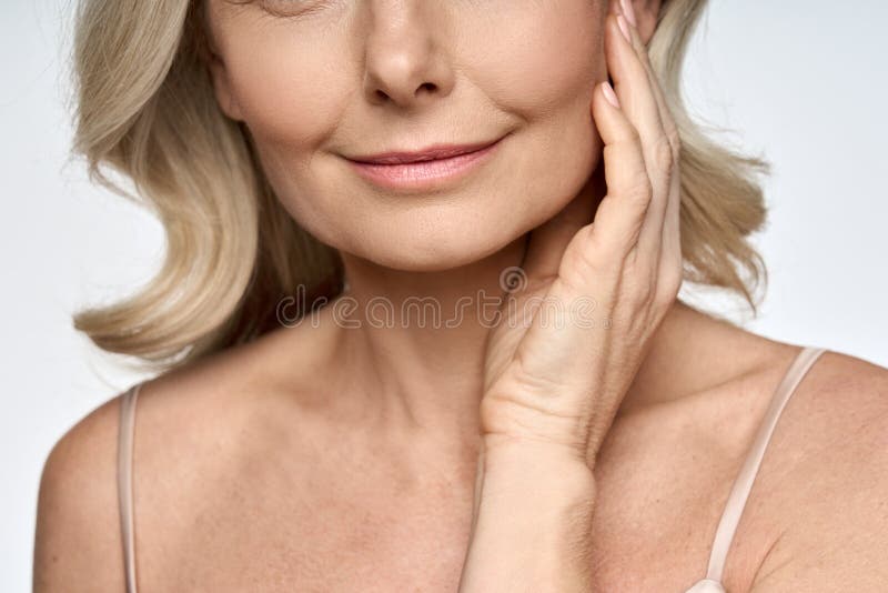 Detailed closeup portrait of face, neck and decollete of 50s aged woman.