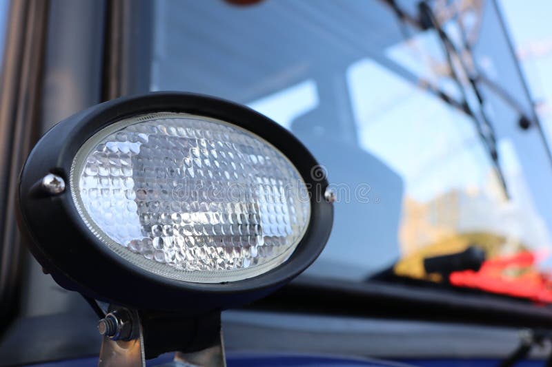 Detailed CloseUp Image of a Tractor Headlight Showing Its Design and Components royalty free stock photography