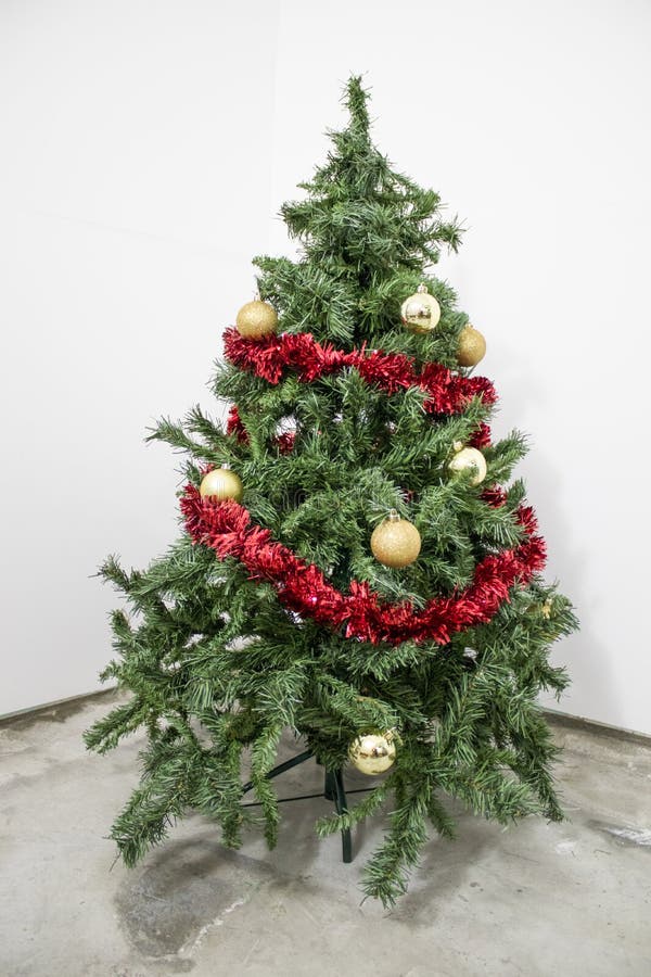 Detailed Green Christmas Tree with Gold Decorations in a White B Stock