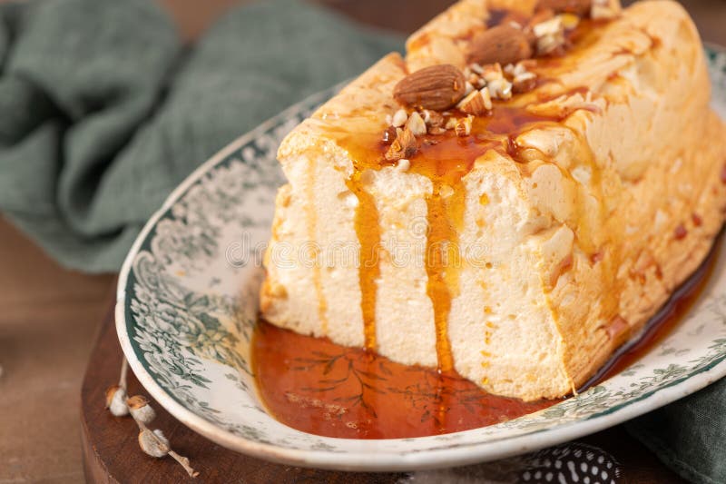 A detailed shot focuses on a traditional caramelized egg white pudding known as molotof or molotov, generously drizzled with rich royalty free stock photography