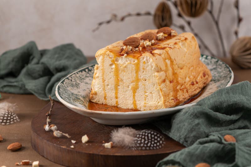 A detailed shot showcases a traditional caramelized egg white pudding known as molotof or molotov, generously drizzled with rich stock photos