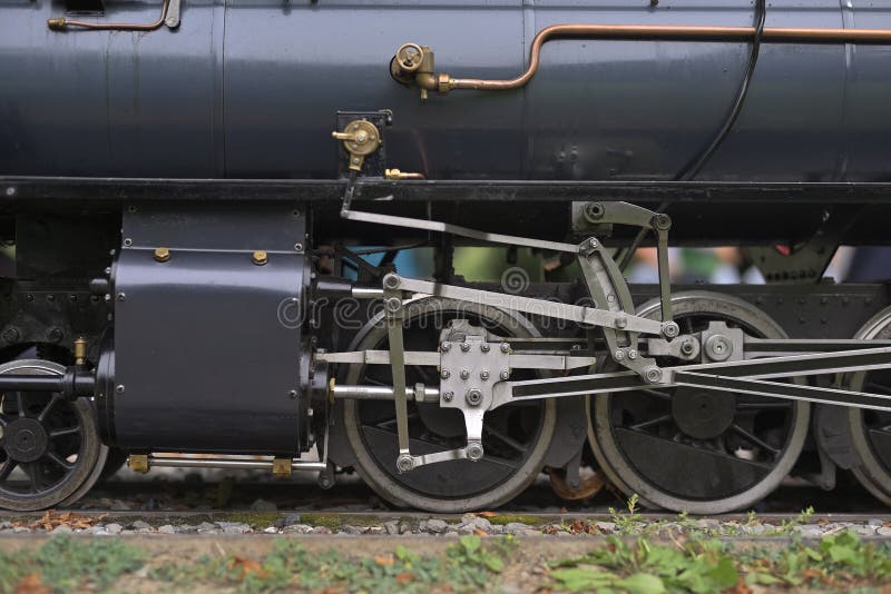 Detailed view of driving wheels and mechanical rods of miniature steam locomotive G 2 3+2 2 RhB 26 model 1:6 in Thun Switzerland stock image