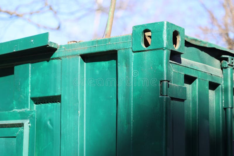 A detailed view of a green trash can with a lid and a handle, suitable for use in illustrations about recycling or waste royalty free stock images