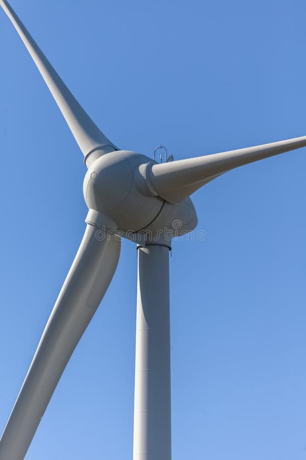 Detailed view of a wind turbine or wind mill, details at the main components: rotor blades, hub, nacelle and generator royalty free stock photo