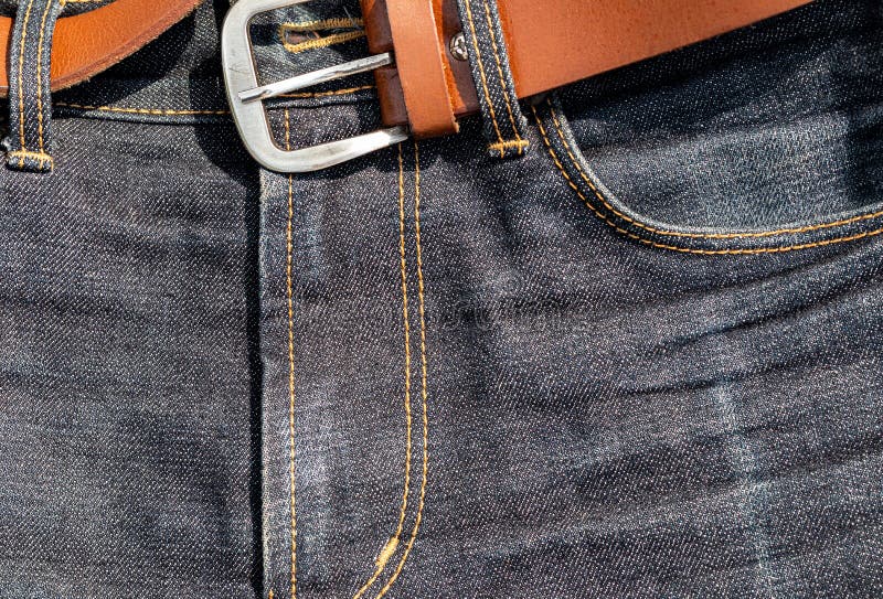 Details of a Brown Leather Belt and Blue Denim Jeans Texture Background