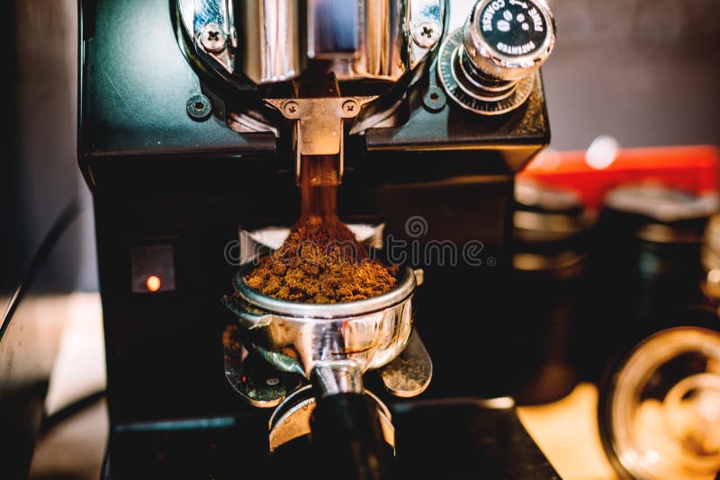 Grinding Coffee, Freshly Grinded Coffee by Barista in Cafe Stock Photo