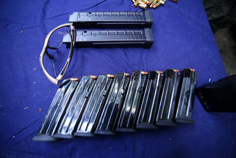 Details with Gun Clips, 9mm Ammunition and Protective Glasses on a
