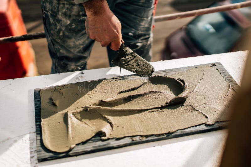 Details of industrial worker using mortar for stone installation on construction site. Bricklayer tiler stock images, royalty-free photos and pictures