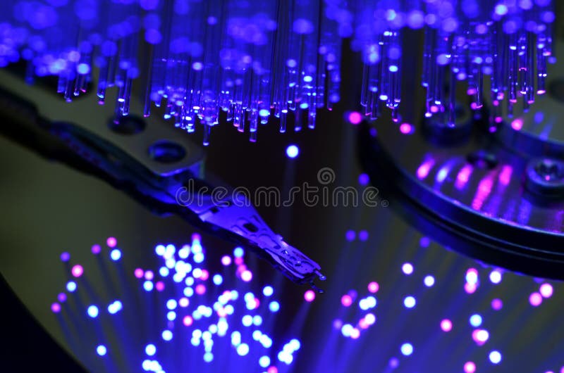 Details of opened computer hard disk drive with colored optic fiber effects royalty free stock image