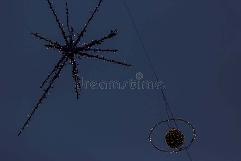 Details of street Christmas lights, snowflakes in the blue sky. Christmas lights. Details of street Christmas lights, snowflakes in the blue sky. Christmas lights