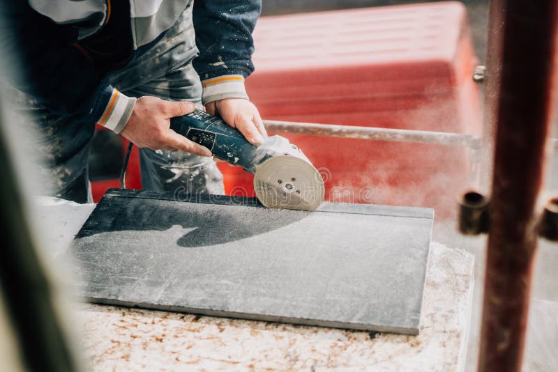 Close up details of worker cutting stone marble with angle grinder at construction site. Bricklayer tiler stock images, royalty-free photos and pictures