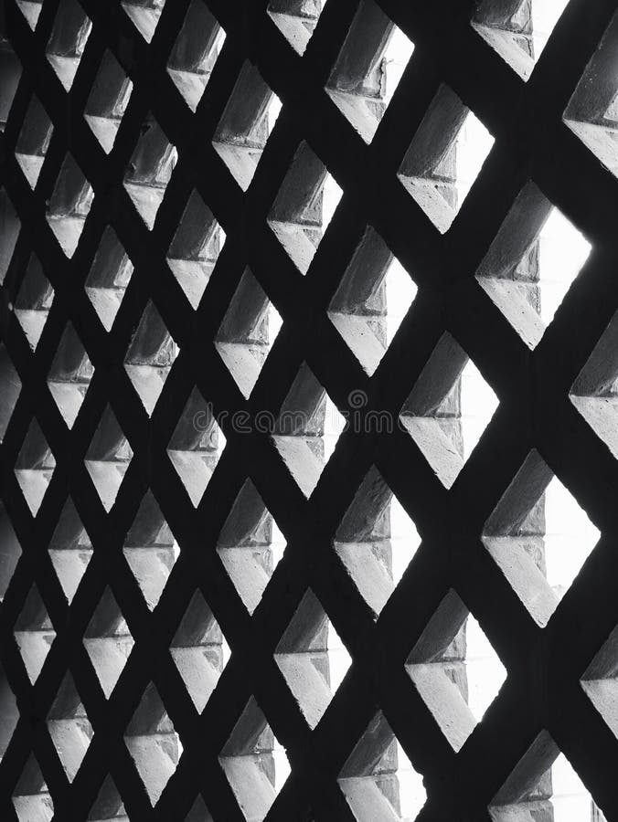 Detalhes da arquitetura da iluminação da máscara do teste padrão da parede do painel do cimento imagem de stock Detalhes da arquitetura da iluminação da máscara do teste padrão da parede do painel do cimento imagem de stock