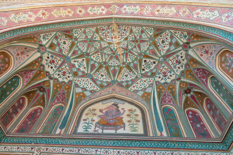 Detail of the entrance to the Ganesh Pol in the Amber Fort, Amer , Rajasthan, India. Ornate gateway to the vast Amber Palace complex, with a painting of the Hindu elephant deity Ganesh. A narrow 4WD road leads up to the entrance gate, known as the Suraj Pol (Sun Gate) of the fort. It is now considered much more ethical for tourists to take jeep rides up to the fort, instead of riding the elephants. Amer Fort or Amber Fort is a fort located in Amer, Rajasthan, India. Amer is a town with an area of 4 square kilometres (1.5 sq mi) located 11 kilometres (6.8 mi) from Jaipur, the capital of Rajasthan. Located high on a hill, it is the principal tourist attraction in Jaipur. Amer Fort is known for its artistic style elements. With its large ramparts and series of gates and cobbled paths, the fort overlooks Maota Lake which is the main source of water for the Amer Palace. Detail of the entrance to the Ganesh Pol in the Amber Fort, Amer , Rajasthan, India. Ornate gateway to the vast Amber Palace complex, with a painting of the Hindu elephant deity Ganesh. A narrow 4WD road leads up to the entrance gate, known as the Suraj Pol (Sun Gate) of the fort. It is now considered much more ethical for tourists to take jeep rides up to the fort, instead of riding the elephants. Amer Fort or Amber Fort is a fort located in Amer, Rajasthan, India. Amer is a town with an area of 4 square kilometres (1.5 sq mi) located 11 kilometres (6.8 mi) from Jaipur, the capital of Rajasthan. Located high on a hill, it is the principal tourist attraction in Jaipur. Amer Fort is known for its artistic style elements. With its large ramparts and series of gates and cobbled paths, the fort overlooks Maota Lake which is the main source of water for the Amer Palace.