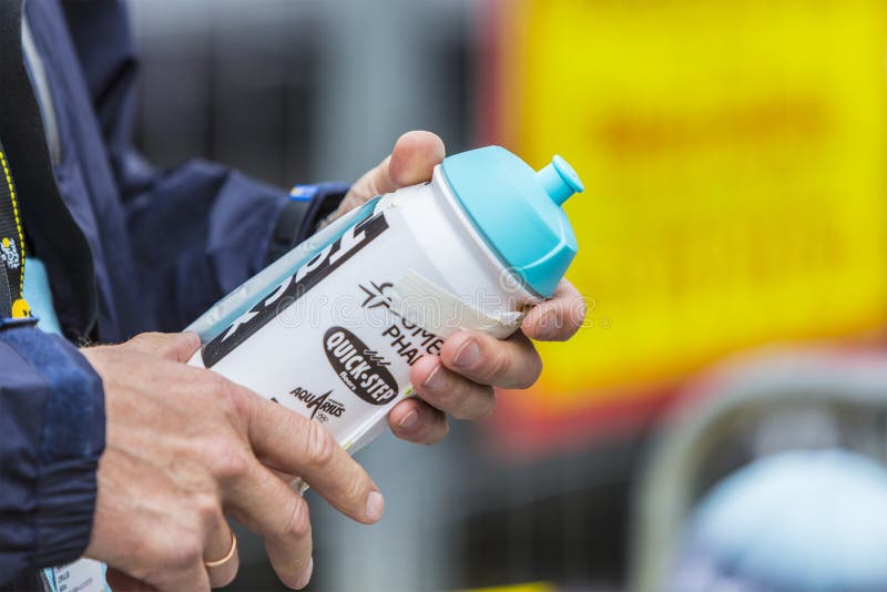 Col du Lautaret, France - July 19, 2014: Close-up image of hands holding a cylcling revitalization kit on Col du Lautaret in Alps during the stage 14 of Le Tour de France 2014. Col du Lautaret, France - July 19, 2014: Close-up image of hands holding a cylcling revitalization kit on Col du Lautaret in Alps during the stage 14 of Le Tour de France 2014.