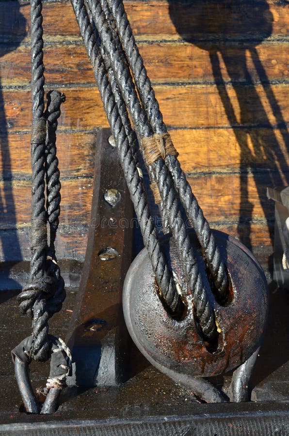 Reels and tar pitch covered ropes of a historic tall ship. Reels and tar pitch covered ropes of a historic tall ship.