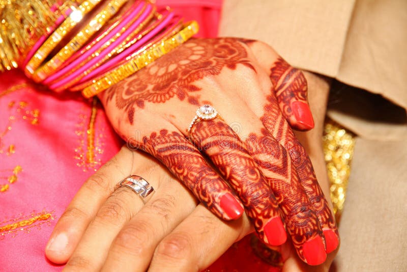 Details from an Indian wedding with henna hands, bangles and rings. Details from an Indian wedding with henna hands, bangles and rings.